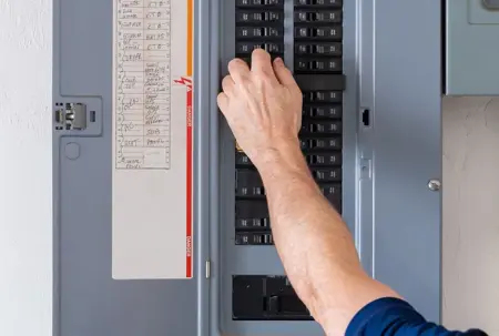 man working on electrical panel