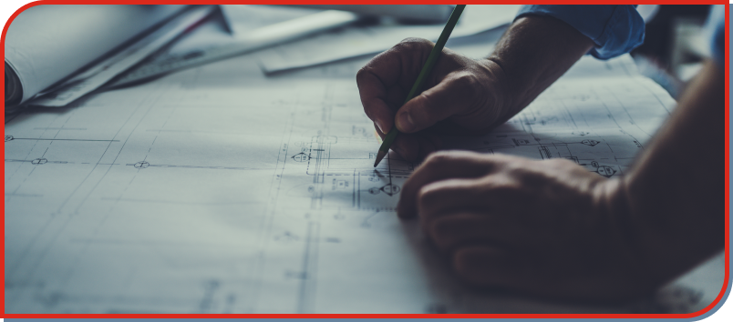 person writing on blue print plans